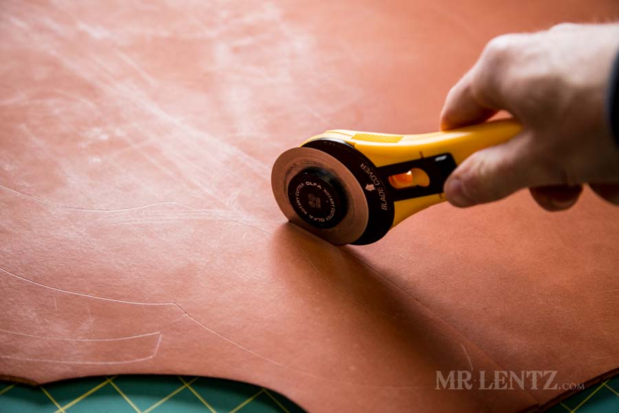 cutting leather to make an axe sheath