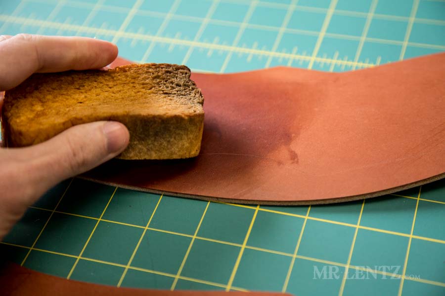 cutting leather to make an axe sheath