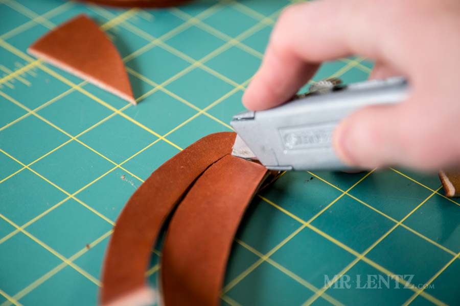 cutting leather to make an axe sheath