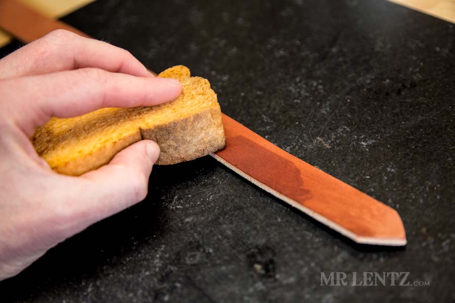 wetting the strap edges in preparation to bevel