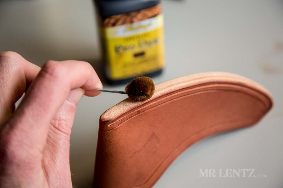 using a wool edge dauber on an axe sheath