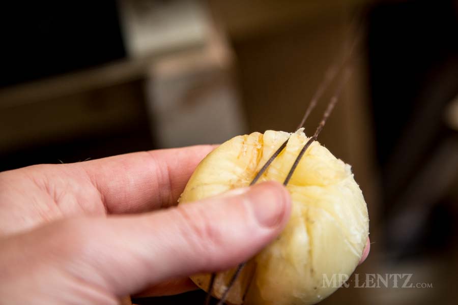 waxing the thread before stitching axe sheath