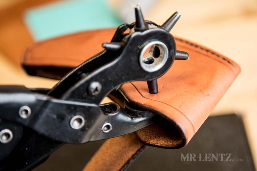 punching a hole on the axe sheath