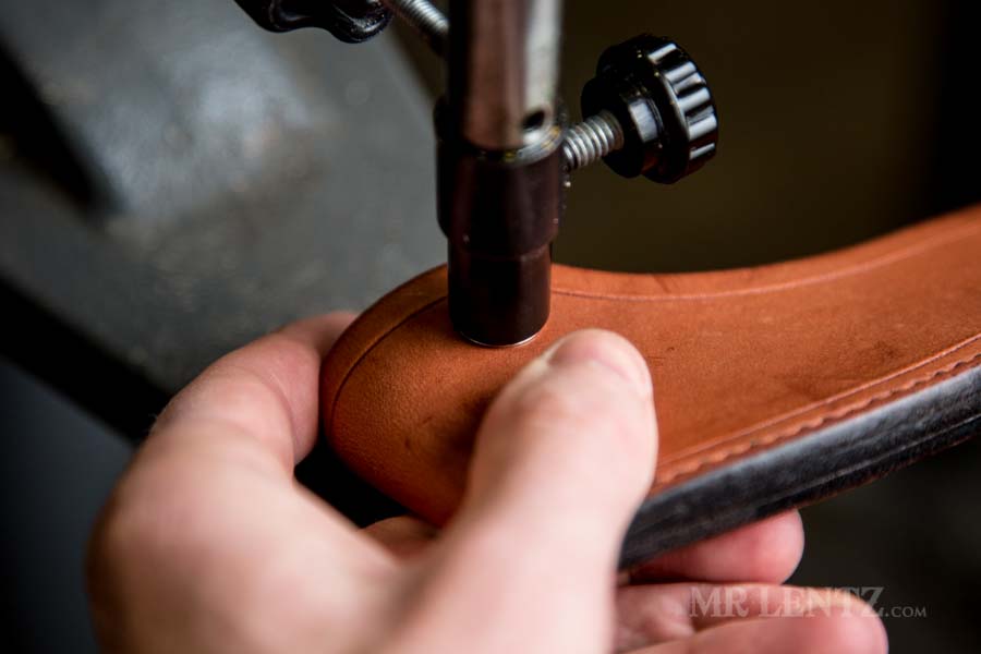 pressing the stud on an axe sheath body