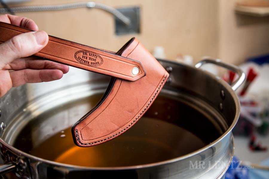 hot wax dipping the axe sheath in beeswax