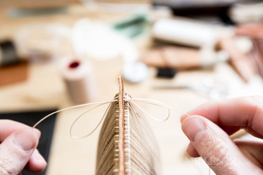 pulling the thread through on a saddle stitched leather item