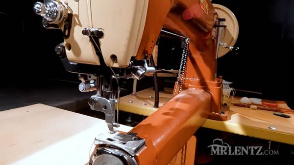 checking the leather sewing machine for any mistakes while threading