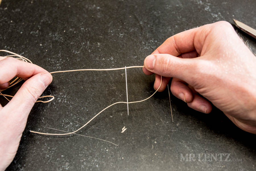 piercing thread on a leather sewing needle