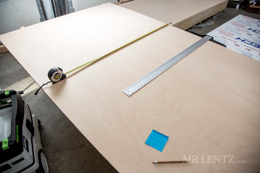 using a t-square and measuring tape on plywood