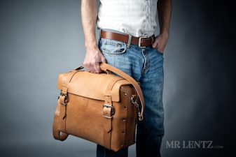 holding the large handmade leather briefcase