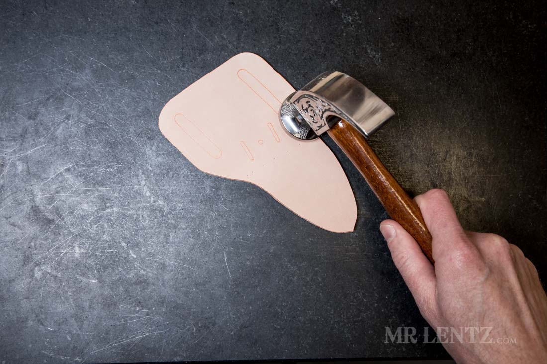 hammering the edge of a leather knife sheath