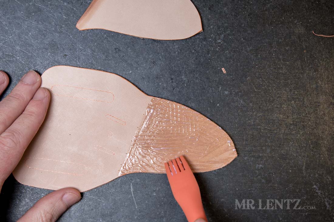 applying glue to a leather piece used in knife sheath making