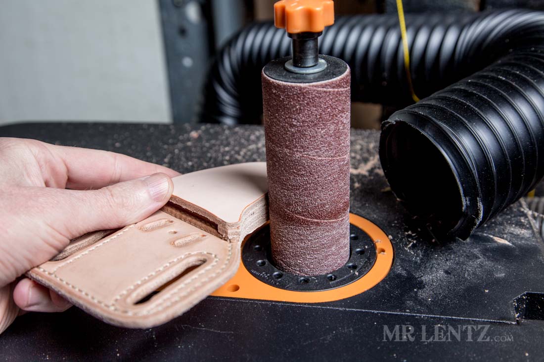sanding the edge of the knife sheath with welt installed