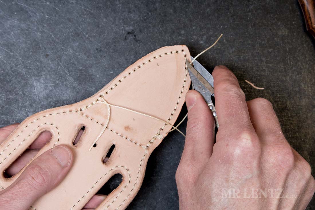 cutting excess thread from back of knife sheath