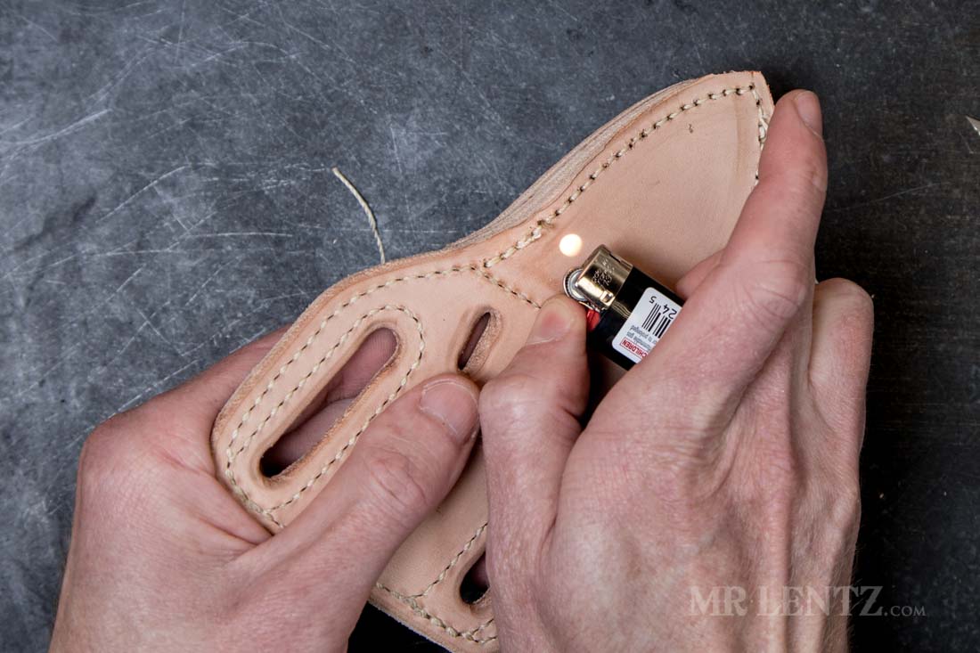 using lighter to burn off excess thread after stitching knife sheath