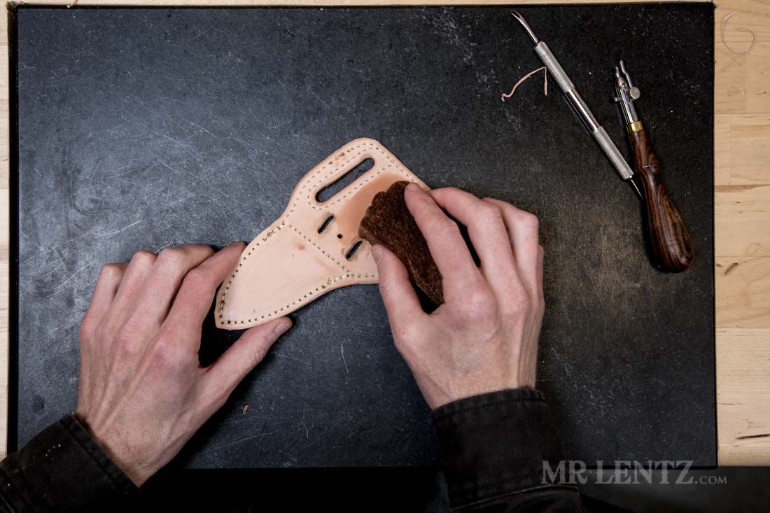 wetting the back of a knife sheath before applying makers mark
