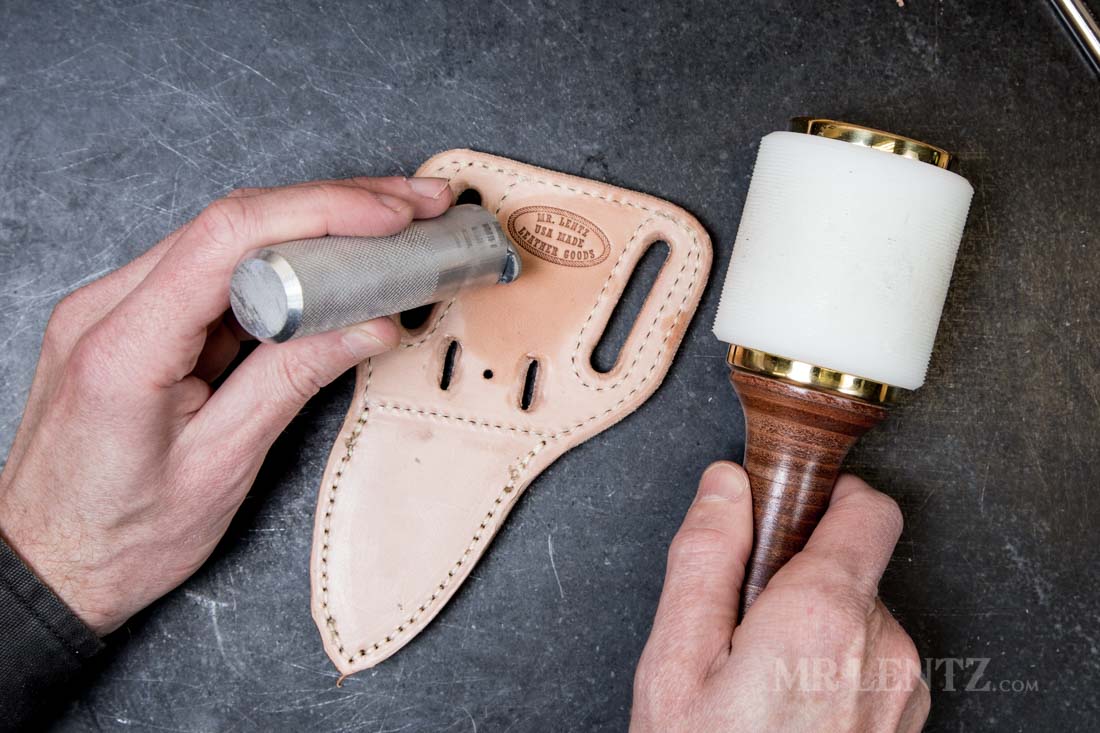 applying makers stamp to leather knife sheath
