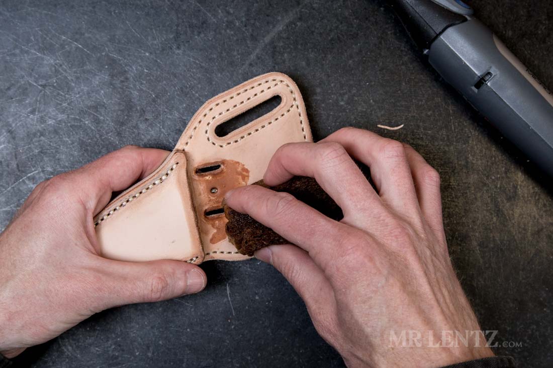 applying water to the retaining strap slot holes