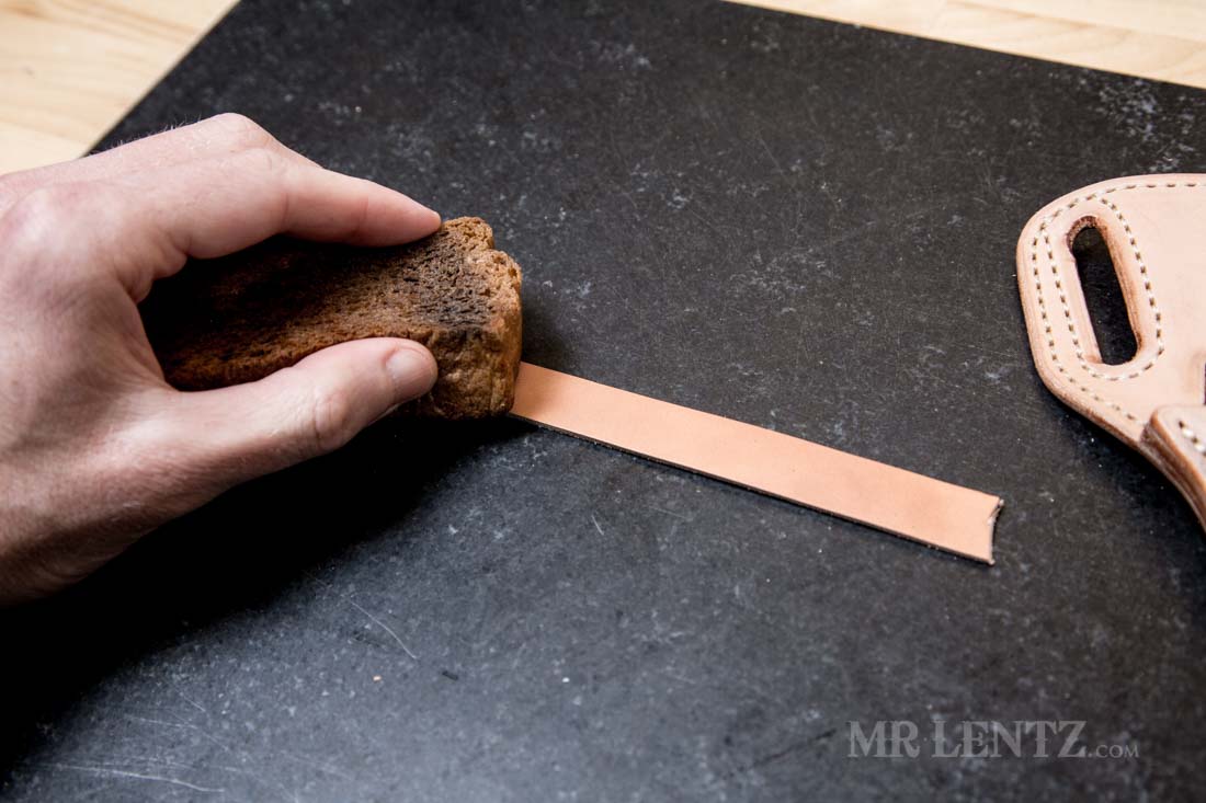 wetting the retaining strap of the knife sheath