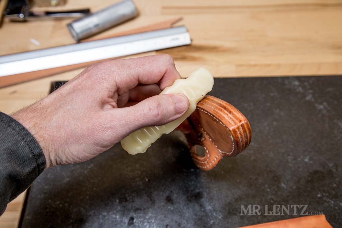rubbing columbus wax on edge of knife sheath