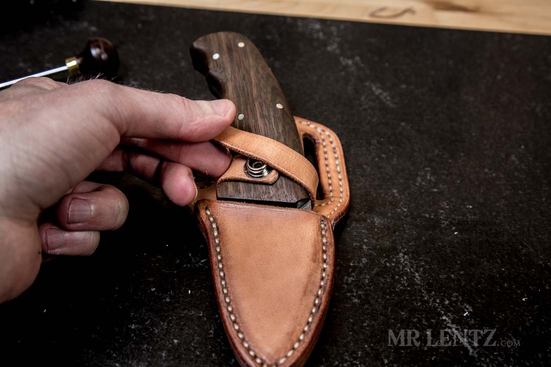 pulling retaining strap together