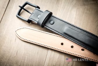 front and back of a fine leather dress belt in black color