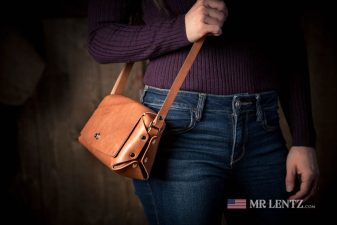 crossbody purse in brown leather being worn by woman