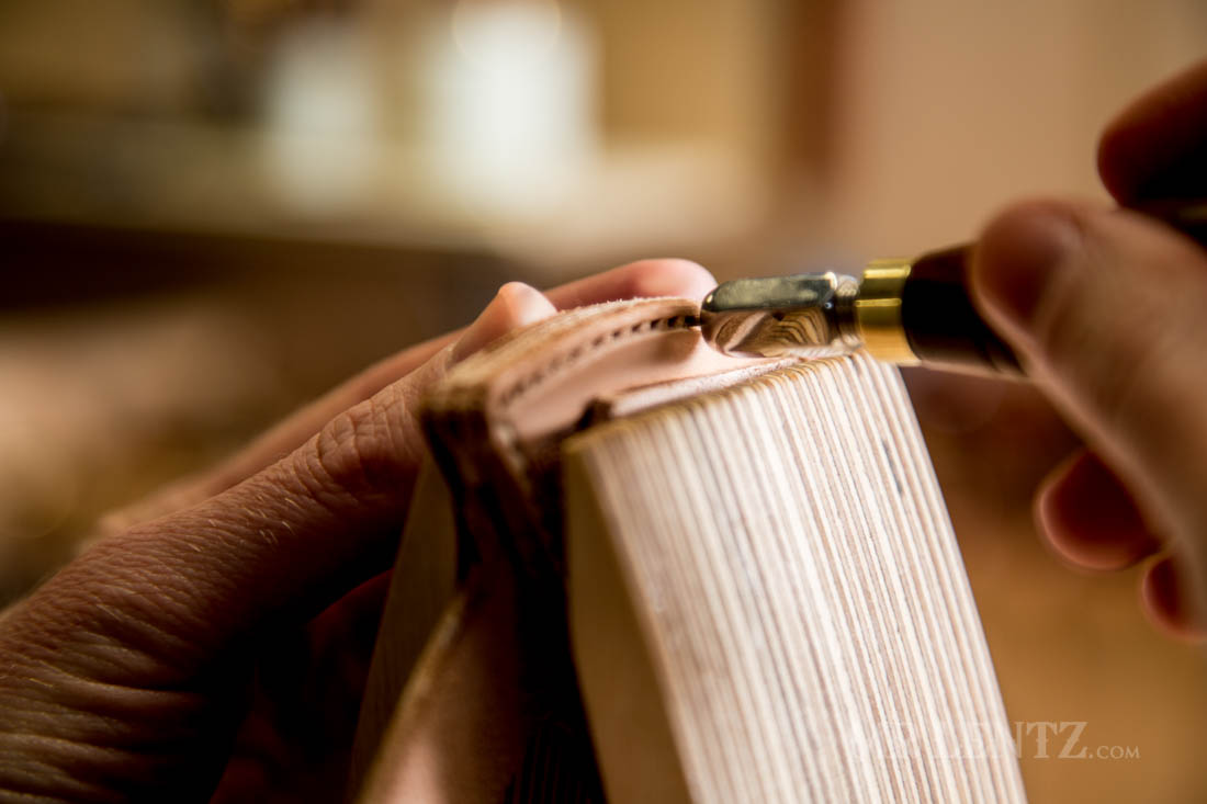 using awl on round knife leather sheath