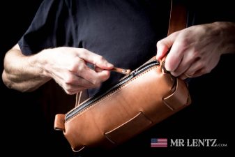 opening a brown leather sling day bag fanny pack