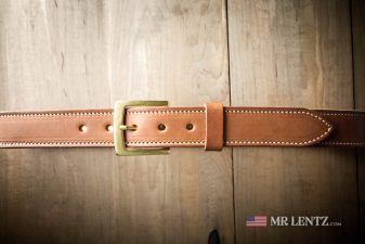 brown stitched belt with brass buckle