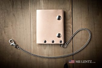 slim chain on tan leather trifold wallet